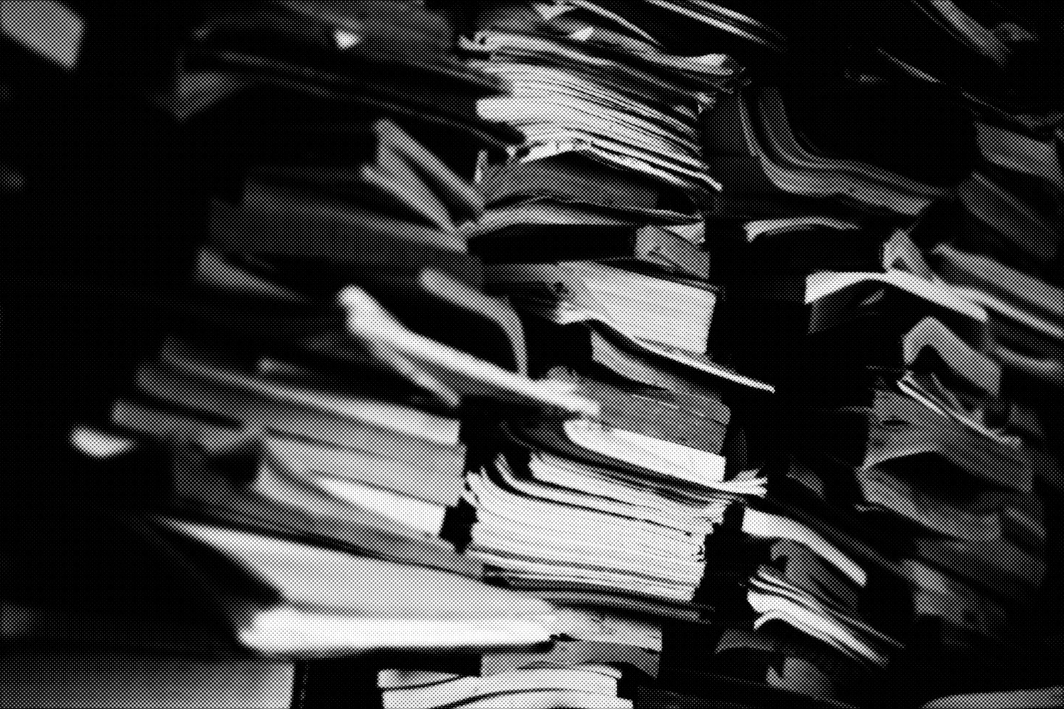 A dark, distorted, halftone image of a a tall pile of old books.